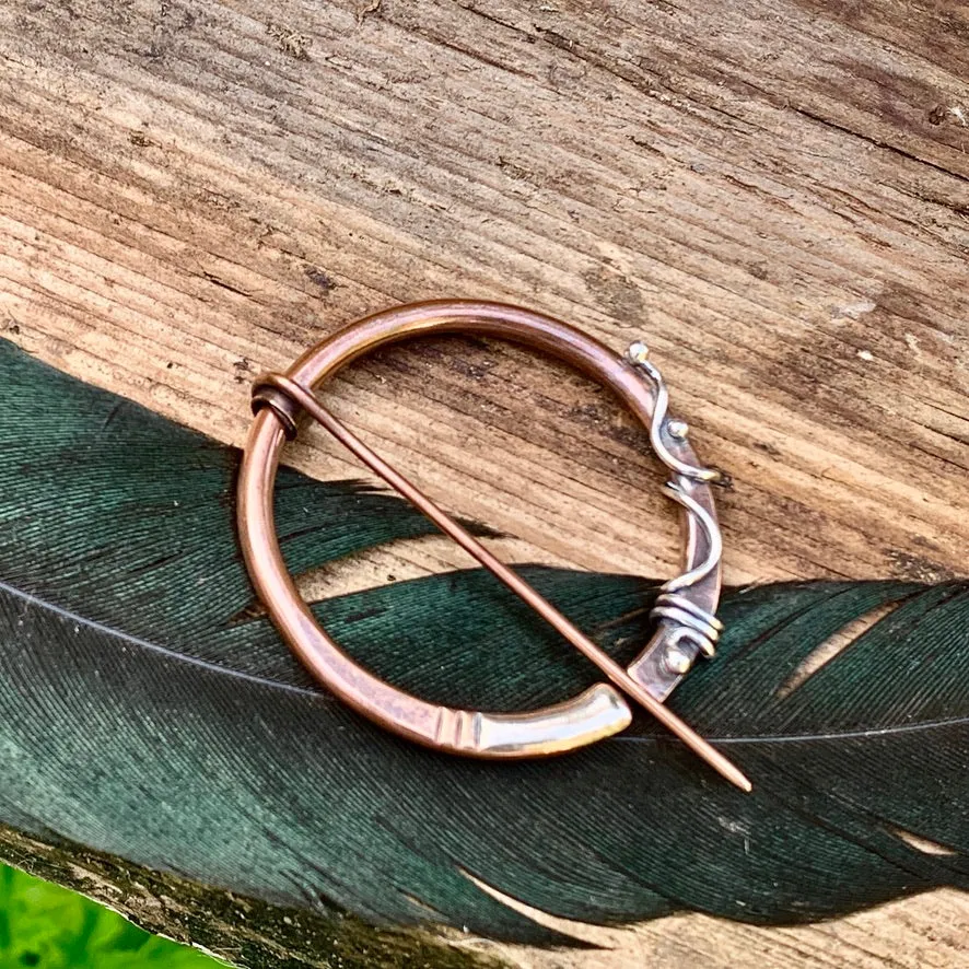 Copper and Sterling silver Pen-annular brooch.