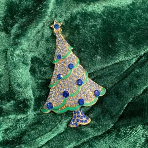 Icy blue Christmas tree brooch with green ribbon.